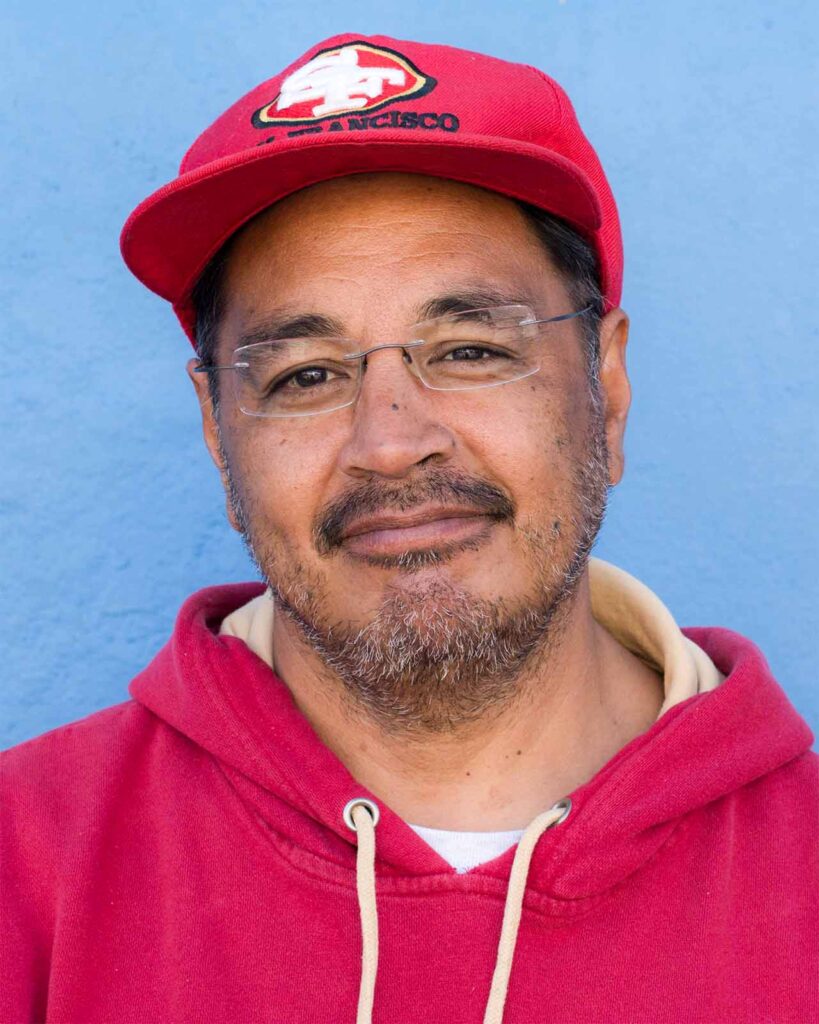 Coach Glenn in a San Francisco 49er's hat and red hoodie.