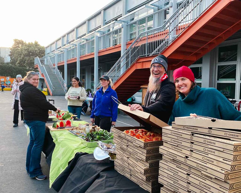 Parents set up pizzas and food at school.